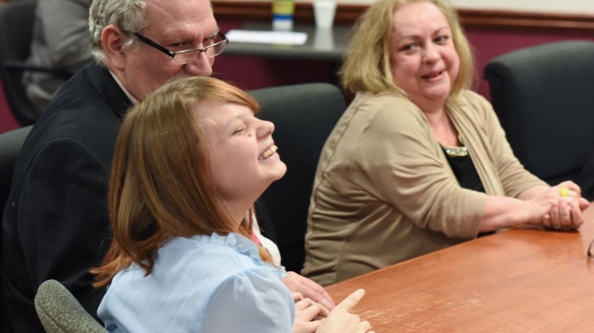 Aryka Yontz, 11, and new parents Phillip and Robin Yontz react to the verdict of Family Court Judge David Guyton, which finalized Aryka’s adoption Tuesday afternoon.