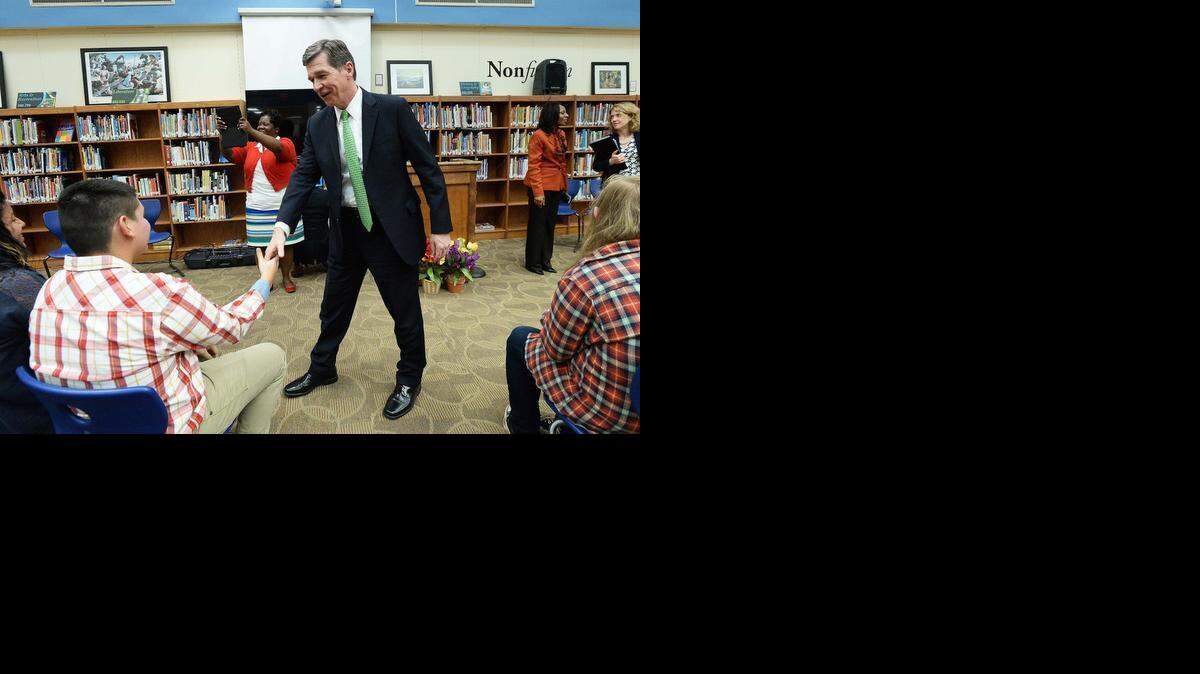 
N.C. Attorney General Roy Cooper, right, shakes hands with Northeast Middle student David Conde, 14, after Cooper spoke at the school Tuesday.




