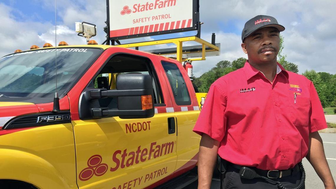 
Kevin Noble, a state Department of Transportation IMAP driver based in Winston-Salem, poses in Raleigh on May 11, 2015, with a DOT truck freshly redecorated to promote IMAP’s corporate sponsor, State Farm.
