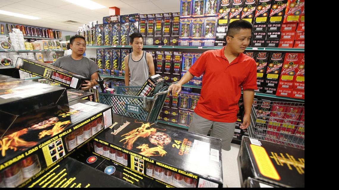 
People buying fireworks for July 4th at Area 51 fireworks next to Carowinds and Frugal McDougal near the state line. Chinew Yang, from left, Jay Vang and Sai Yang shop for fireworks.
