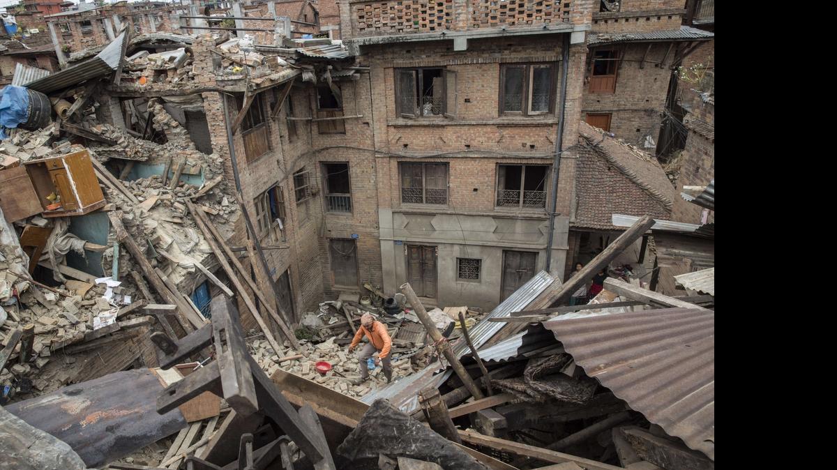 
In this handout photograph by the International Federation of Red Cross and Red Crescent Societies a man walks through the rubble in Bhaktapur near Kathmandu on Tuesday  following a 7.8 earthquake which struck the Himalayan nation on April 25. 
