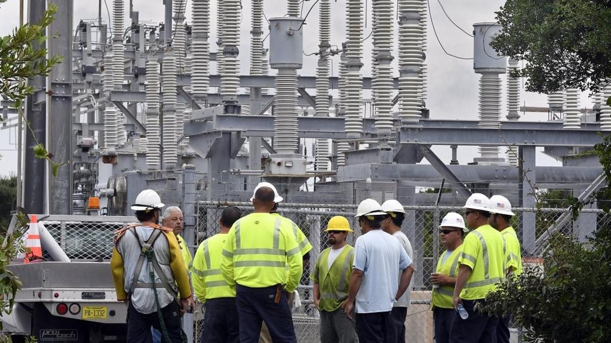 Cape Hatteras Electric Cooperative linemen get orders from a supervisor at a Hatteras Island substation where generators are running after a construction crew cut the power cable that supplies Hatteras Island with electricity, Saturday, July 29, 2017. The men were to man the generators and monitor fuel and discharge rates to keep local residents out of the dark.