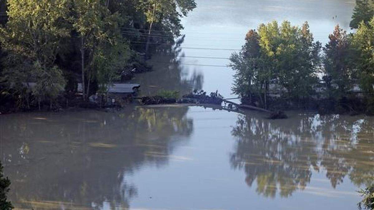A road is washed out from flooding in Columbia, S.C., Tuesday, Oct. 6, 2015. Despite an improving forecast, it will still take weeks for the state to return to normal after being pummeled by an historic rainstorm.