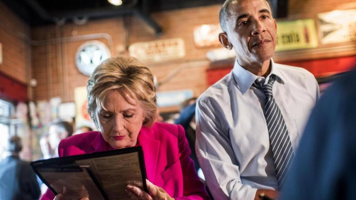 Democratic presumptive nominee Hillary Clinton and President Barack Obama prepare to order some barbecue at Midwood Smokehouse after a rally in Charlotte, North Carolina on Tuesday.