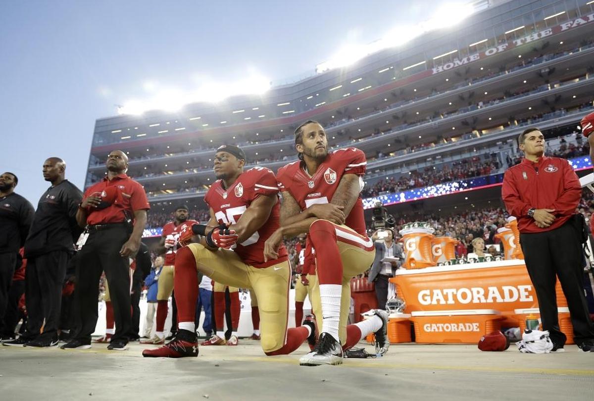 San Francisco 49ers safety Eric Reid (35) and quarterback Colin Kaepernick (7) kneel during the national anthem before an NFL football game against the Los Angeles Rams in Santa Clara, Calif.