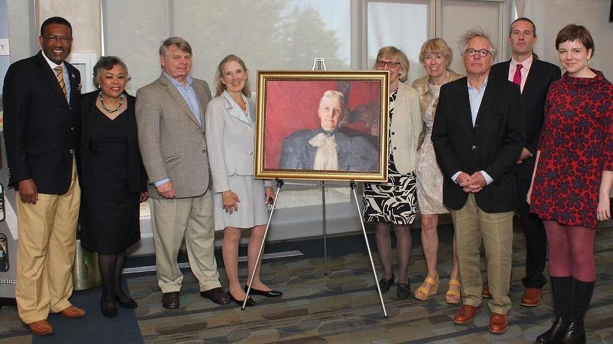Johnson C. Smith University president Ronald Carter, left, with Biddle descendants and a portrait of benefactor Mary Biddle at the university’s 150th anniversary celebration.