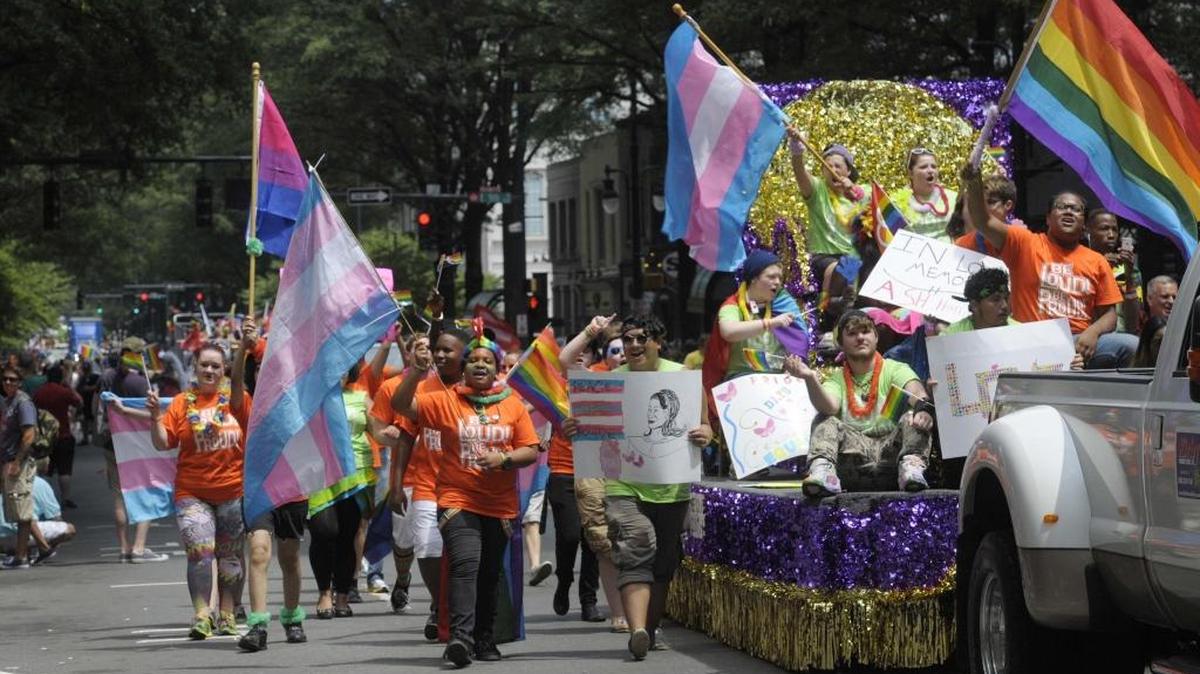 Time Out For Youth members march along Tryon Street in Uptown during the 2015 Charlotte Pride Parade