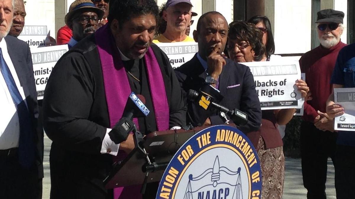 The Rev. William Barber, leader of North Carolina’s NAACP, speaks at Friday’s news conference as national NAACP President Cornell Brooks looks on. They were announcing the first steps in a national economic boycott of the state over conservative policies, including House Bill 2.