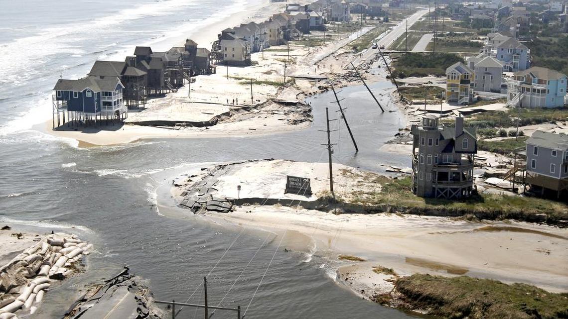 This aerial view looks south of Highway 12 where the Atlantic Ocean breached the road on Hatteras Island north of Rodanthe, after Hurricane Irene swept through in August 2011. The hurricane cut the road in five locations. On Tuesday, the Pea Island Interim Bridge on Hatteras Island was named in honor of Captain Richard Etheridge. The former slave became the leader of the Pea Island Life-Saving Station, an all-African American Coast Guard unit credited with saving countless lives.