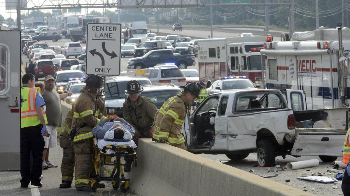 One victim is put on a stretcher by Charlotte-Mecklenburg firefighters following at 2011 fatal crash on Interstate 85.