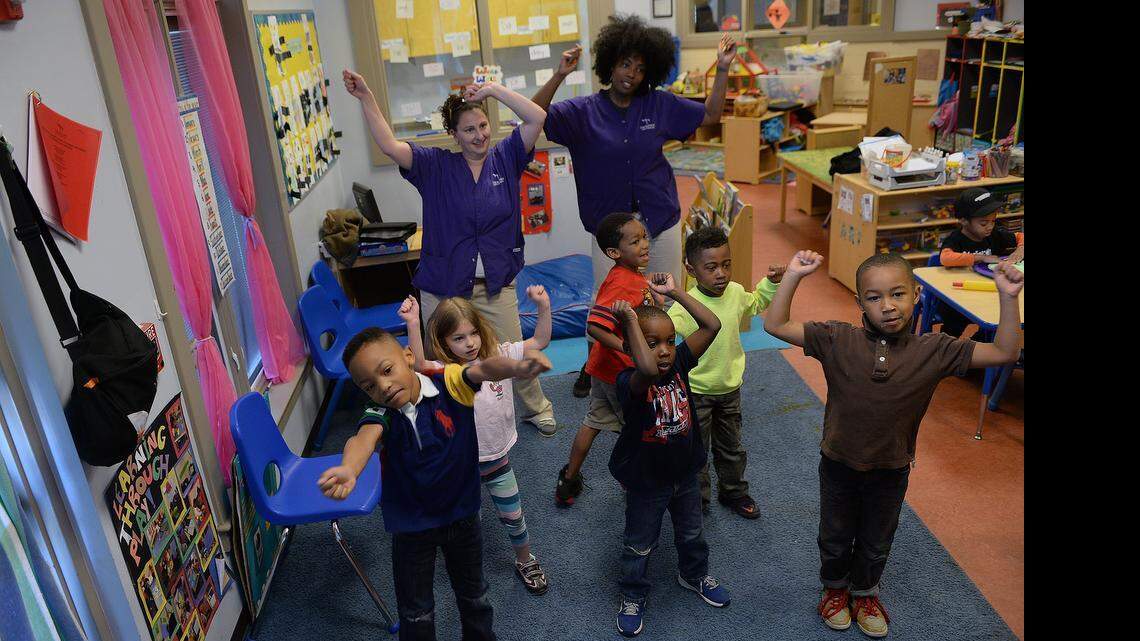 
Students in the pre-K class start their dance exercise Monday with instructor Rochelle Maignan, right, and volunteer parent, Emily Stinebaugh. This is one of the many programs offered by Charlotte-based Thompson Child & Family Focus. 
