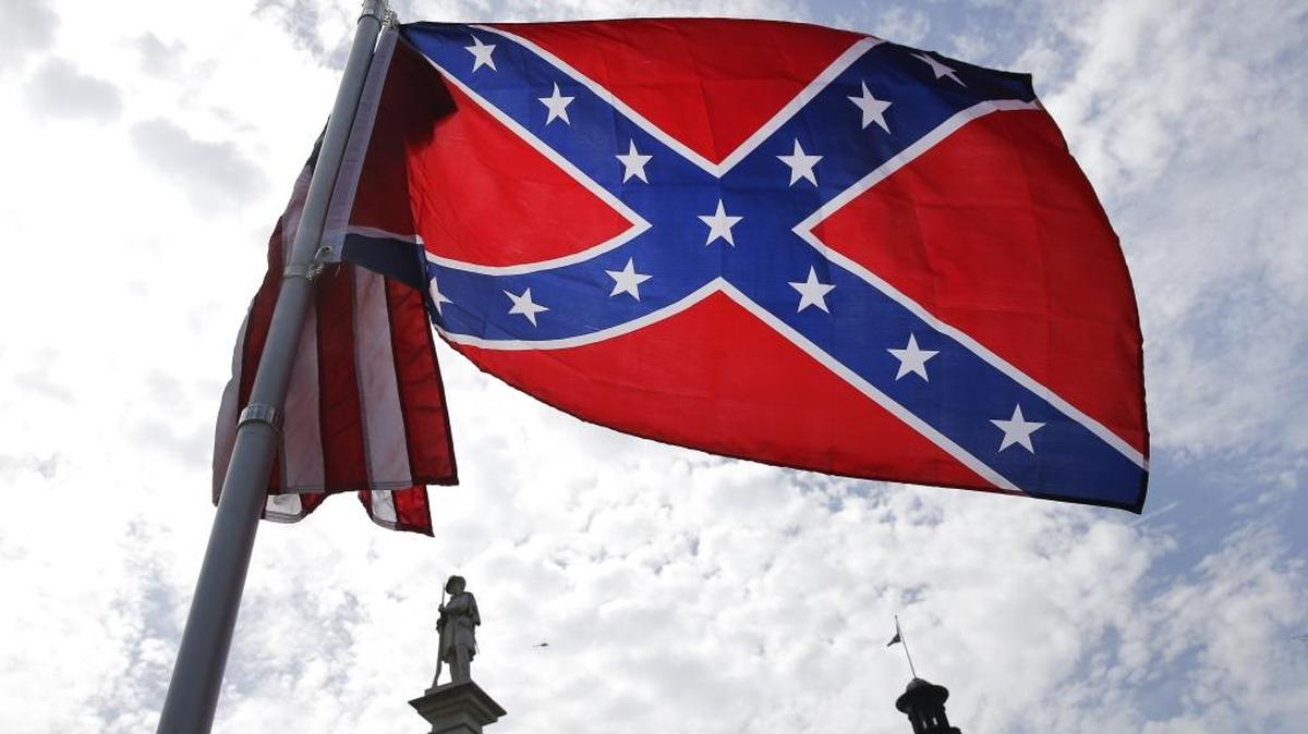 A protester waves a Confederate flag in front of the South Carolina statehouse in this 2015 file photo. York Technical College has a contract to host a 2017 convention with the Sons of Confederate Veterans, which supports the flag.