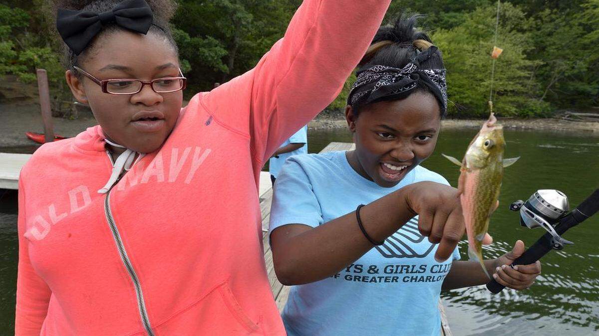 
Olivia Hilt, 12, watches as friend Kaela Ferguson, 12, touches the fish she just caught at McDowell Nature Preserve at Lake Wylie, Friday, July 24, 2015. Olivia and Kaela were part of a larger group from The Salvation Army Boys & Girls Clubs of Greater Charlotte that learned to fish as part of the North Carolina Wildlife Federation, Great Outdoors University program.

