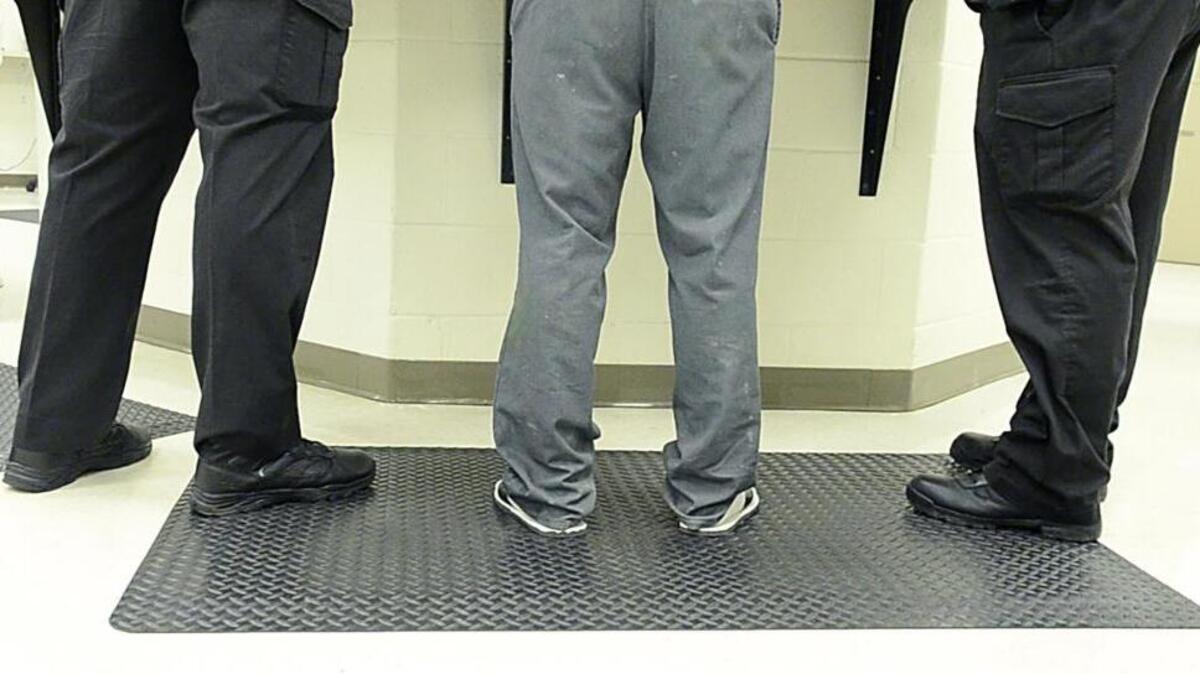 A person goes through initial processing at the booking desk of Mecklenburg County Jail Central.