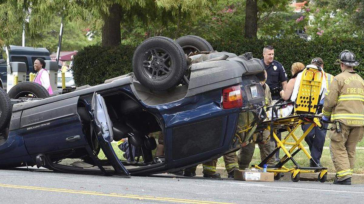 
CFD firefighters roll an accident victim to a waiting EMS ambulance Tuesday. A two car accident at the corner of Davidson and 3rd Streets in uptown Charlotte flipped one of the vehicles on to its roof. At least one person was taken by EMS to the hospital. The wreck happened about 10:45AM Tuesday, August 11, 2015. 
