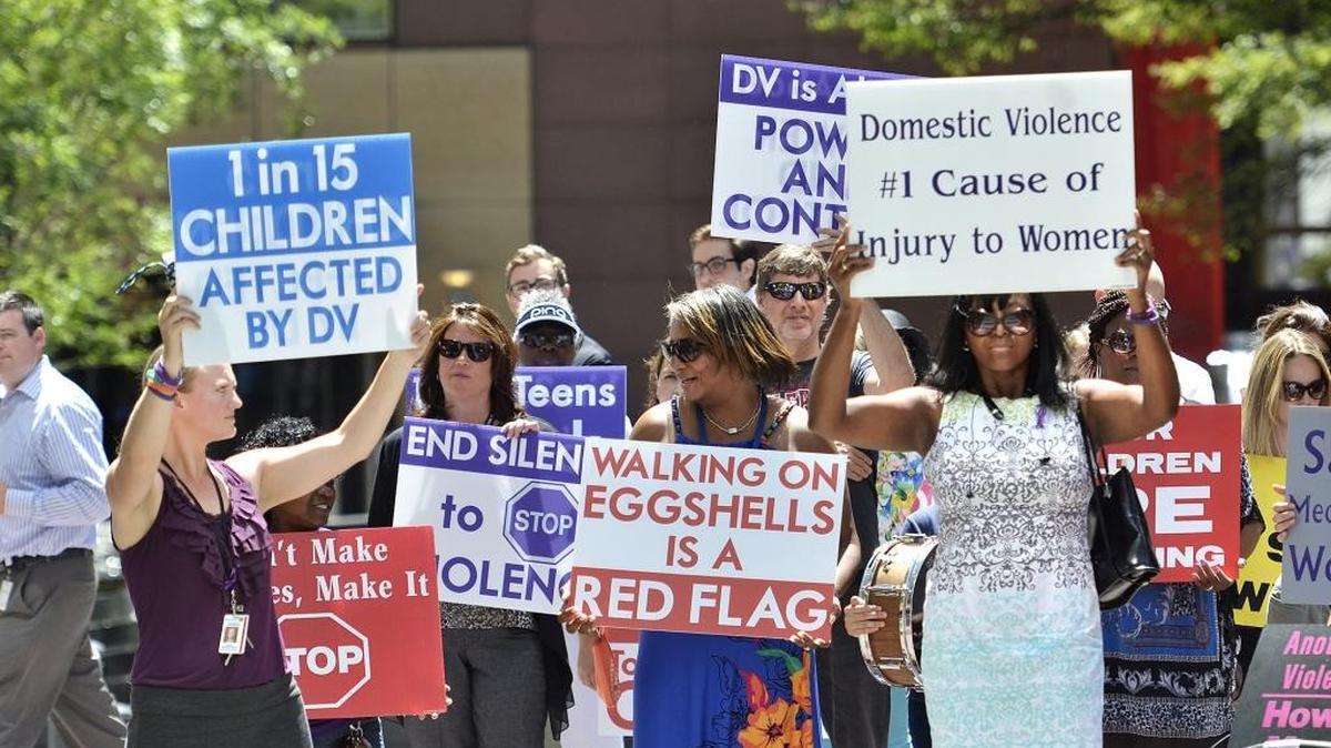 In this file photo, a crowd of men and women rally at the Square at Trade and Tryon streets in uptown Charlotte to raise awareness concerning domestic violence-related homicides and abuse.