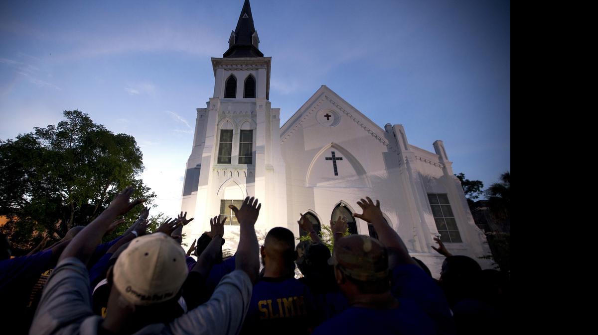 
The men of Omega Psi Phi Fraternity lead prayer outside the Emanuel AME Church on Friday after a memorial in CharlestonThe brick Gothic revival edifice, completed in 1891  was a stop for Booker T. Washington and the Rev. Martin Luther King Jr. 
