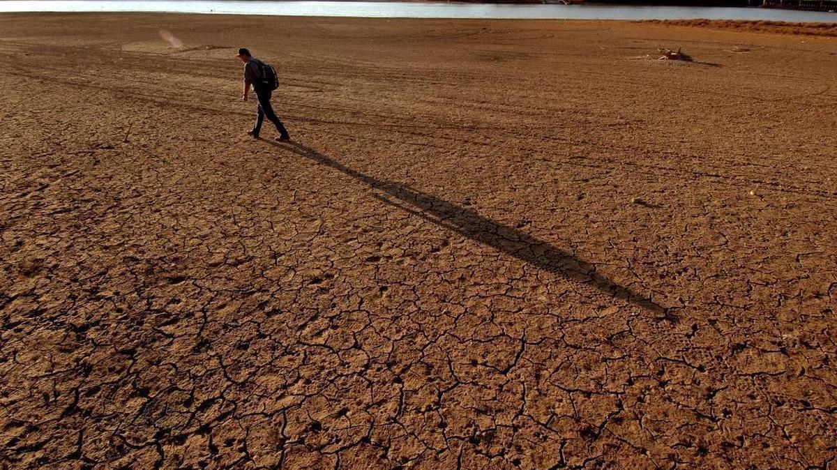 A man walks across the dried flats of the Catawba River in western Mecklenburg County during a severe 2007 drought.