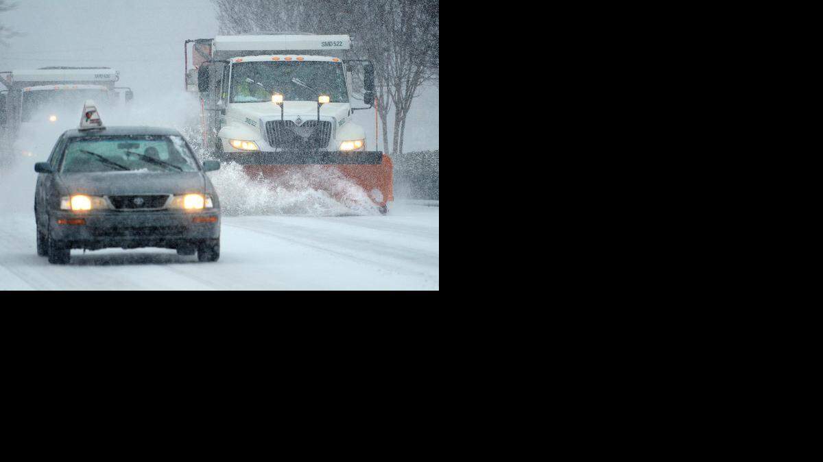
Food delivery drivers and snow plows travel along Prosperity Church Road in Charlotte during a 2014 winter storm. 


