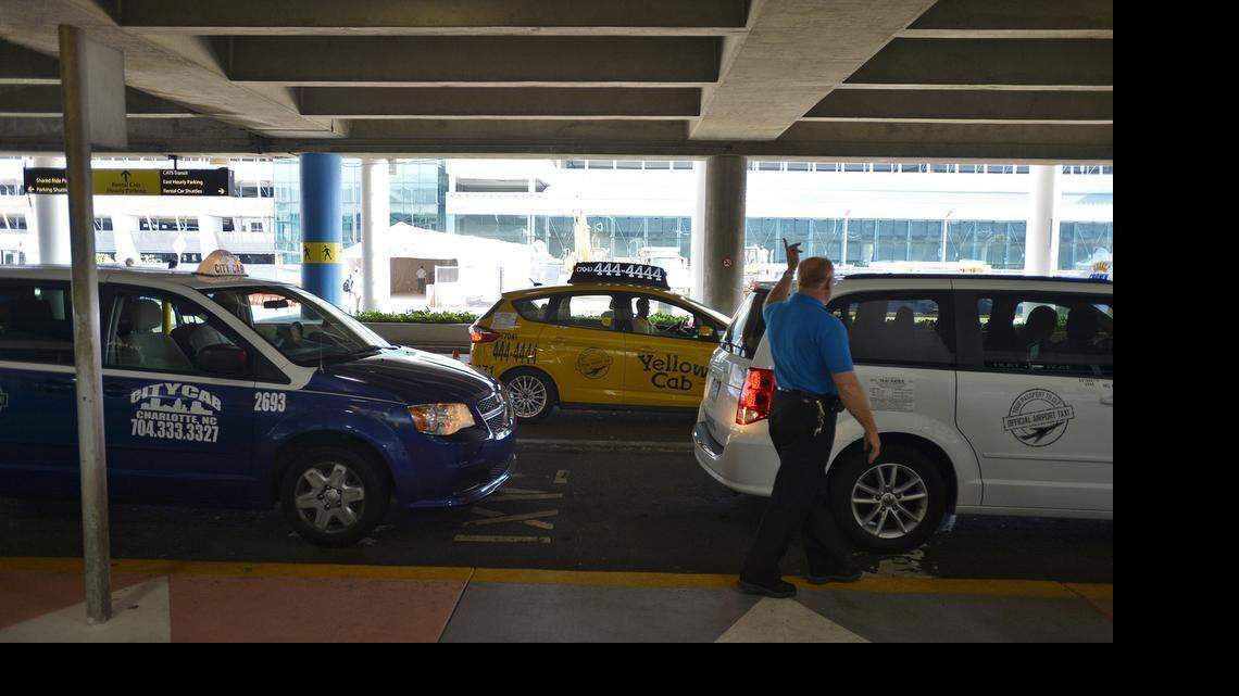 
Taxicabs line up at Charlotte Douglas International Airport Wednesday, June 17, 2015. The airport has deciding to continue, for another year, a deal in which there are only three taxi cab companies at the airport.
