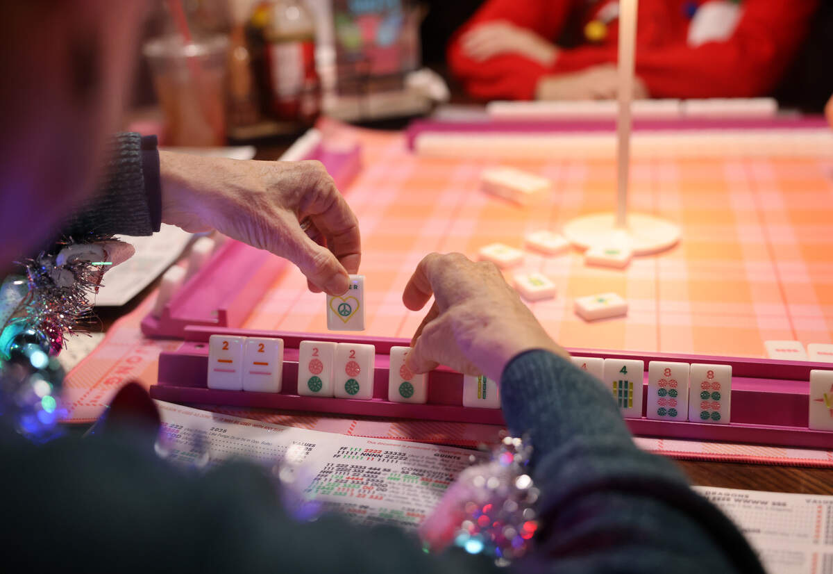 A participant plays a game of mahjong at Salud Cerveceria in NoDa. Eastside Mahjong, a local group teaching mahjong and hosting game nights, held an event at the brewery. 