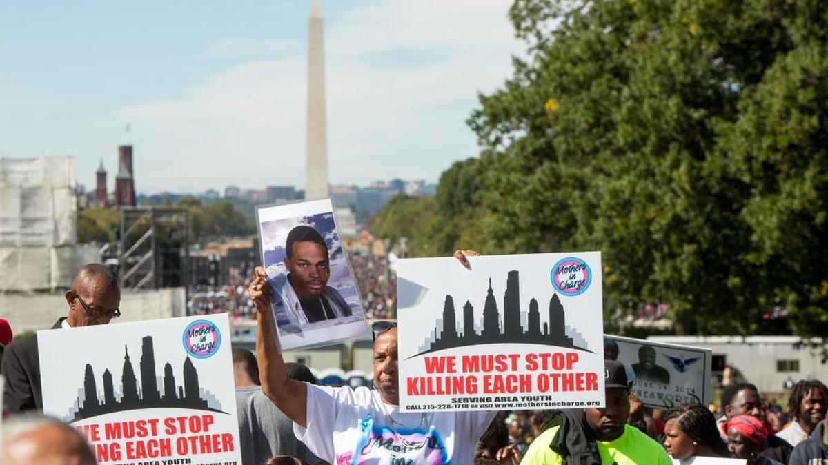 
Attendees holding signs rally on the National Mall and West Lawn of the U.S. Capitol building for "Justice or Else," a rally held to commemorate the 20th anniversary of the Million Man March on October 10, 2015 in Washington, D.C. The rally organized by Nation of Islam leader Louis Farrakhan incuded speakers from the 1995 rally and current civil rights leaders. 

