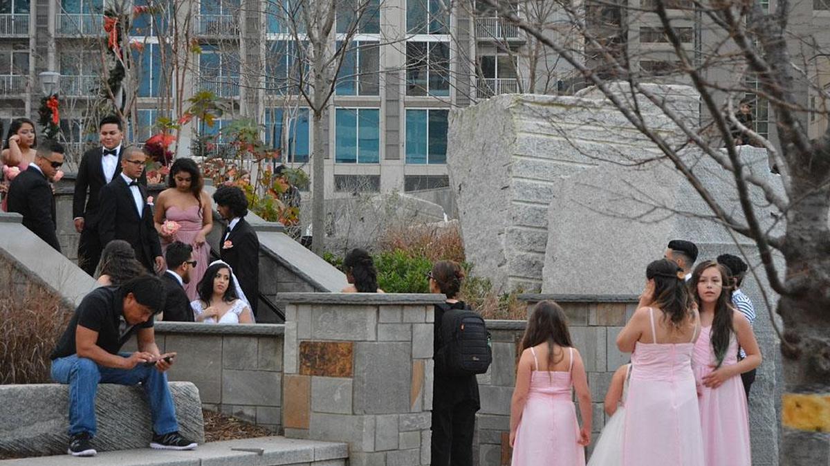 A wedding party gathers for a photo at Romare Bearden Park in uptown Charlotte on Saturday, when the high temperature in Charlotte hit 73 degrees a day after Christmas.