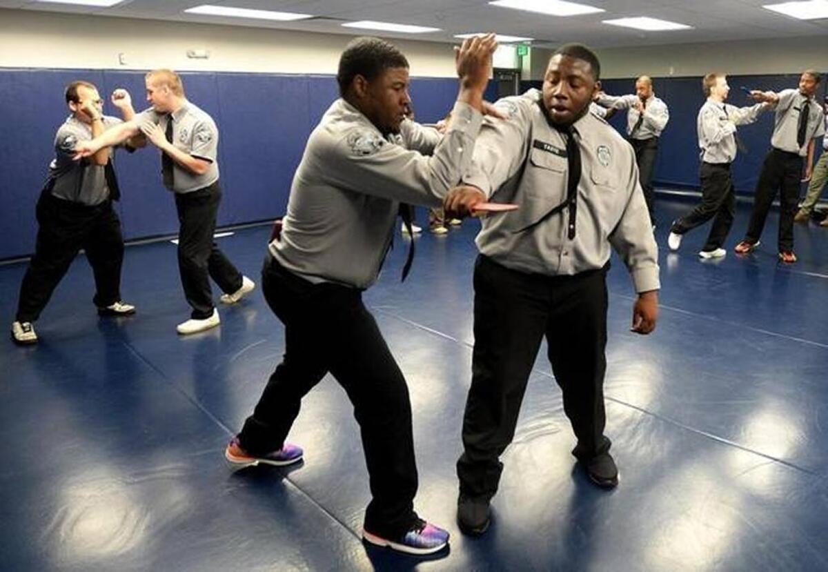 Prison officers Darius Lawson, left, and Joshua Taste, right, take part in a self-defense class at Samarcand Training Academy in Jackson Springs, N.C.