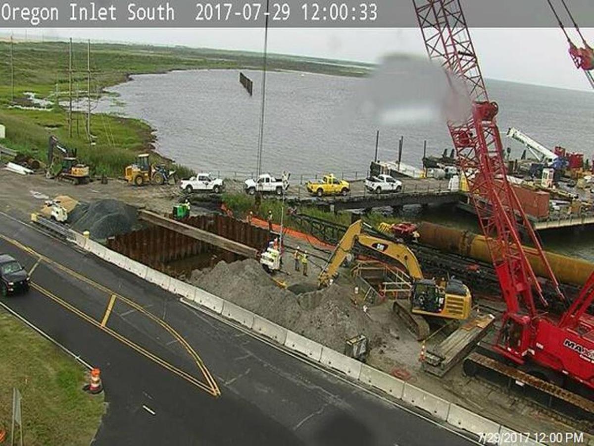 This photo at noon Saturday from an N.C. Department of Transportation camera looking south from the Bonner Bridge shows a trench box, pictured directly in front of the excavator, where crews dug to access the transmission cable damaged Thursday morning, cutting power to Hatteras and Ocracoke islands.
