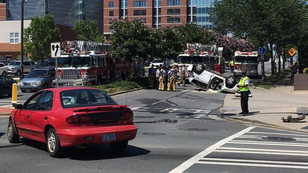 One person was hurt when a car landed on its roof at South Caldwell Street and East Fourth Street in uptown Charlotte on Friday afternoon, the Charlotte Fire Department said.