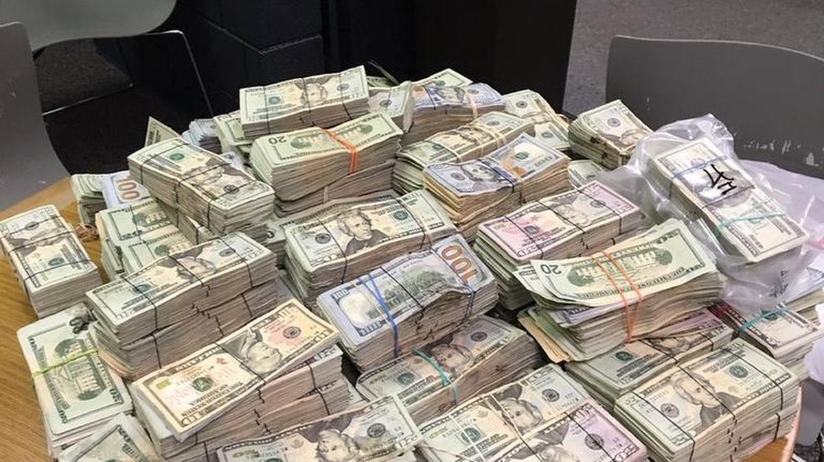Charlotte-Mecklenburg police officers found about half a million dollars in cash inside a Steele Creek home connected to the drug trade.