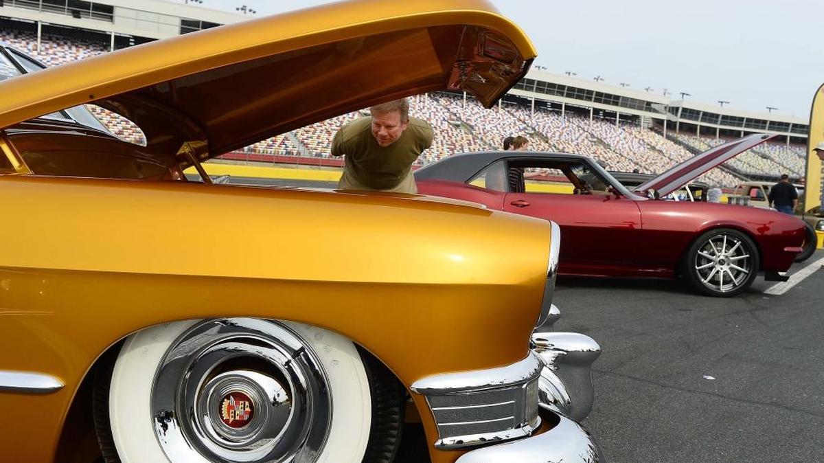 Bill Phillips of Cornelius takes a close up look at the engine on a 1949 Cadillac convertible owned by Chris and Lori Ryan of Ninety Six, S.C., during the Goodguys Southeastern Nationals Sunday.
