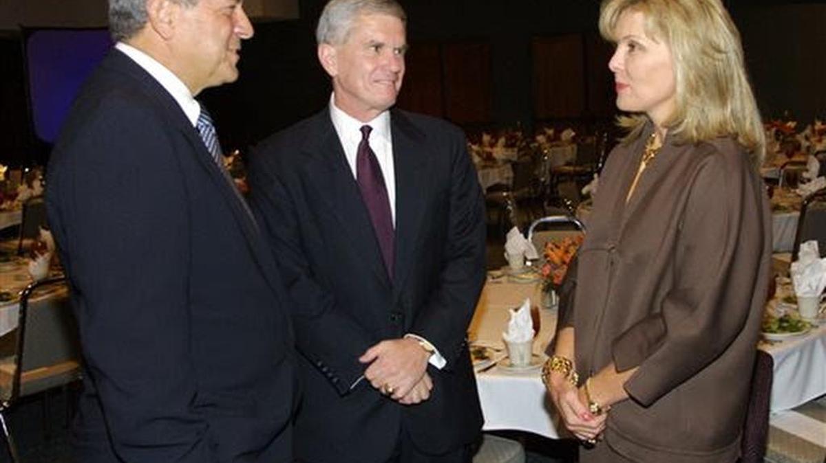 
In this Oct. 18, 2002 file photo, Richard Rainwater, left, and his wife Darla Moore, right, talk with Clemson University President Jim Barker before announcing a gift of $10 million to the university in Clemson, S.C. 
