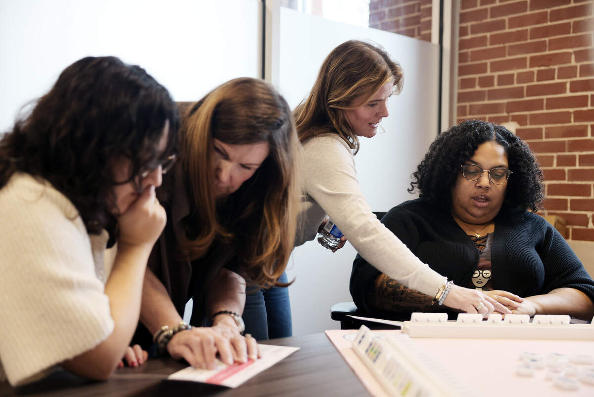 Mahjong instructor Patti Roth, second from right, teaches Charlotte Observer reporter Desiree Mathurin how to play the game on Wednesday, Feb. 11, 2026 in Charlotte. Roth, along with Lauren Ulrey and Jennifer Ross, will open the Queen's Mahjery in Oakhurst.