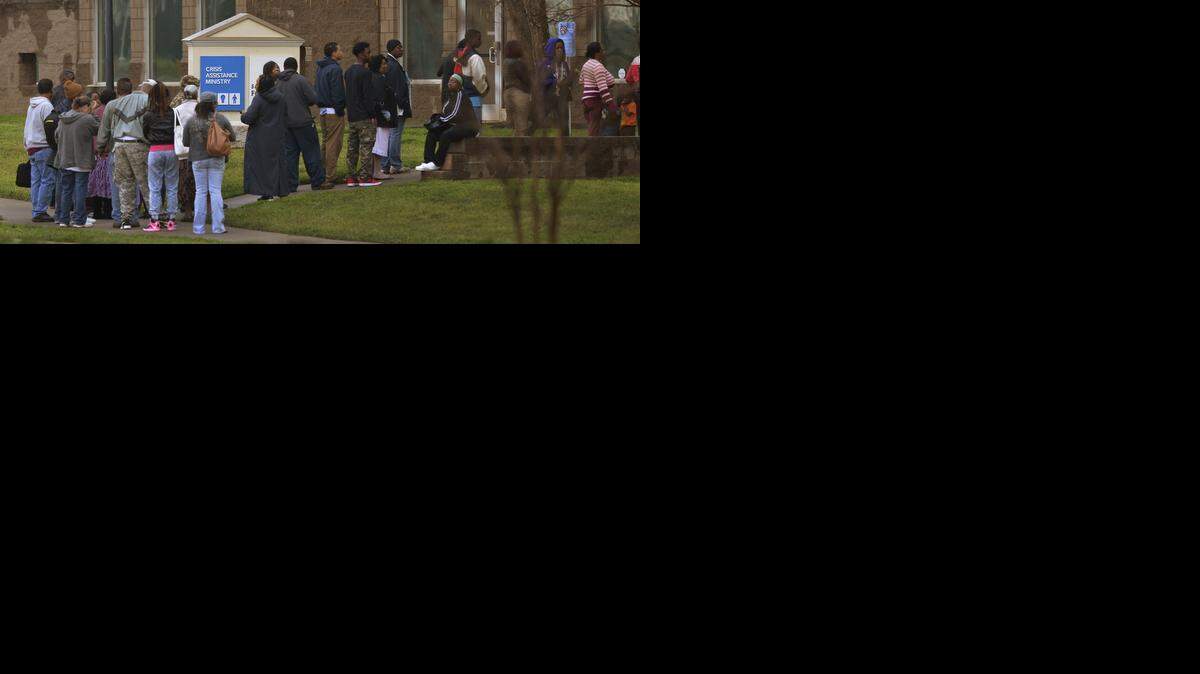 
People in line outside Crisis Assistance Ministry early Tuesday morning, April 07, 2015. Leaders from CPI Security and business investments Babson Capital have each promised to donate $50,000 creating a challenge pool of $200,000 to match dollar-for-dollar donations to Crisis Assistance Ministry from now until April 16th.
