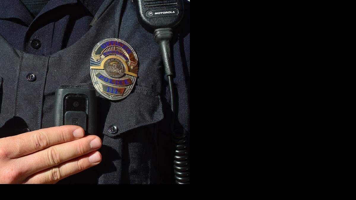 
Officer N.J. Bockler of the Davidson Police Dept., switches on his body camera in Davidson Nov. 11, 2014.
