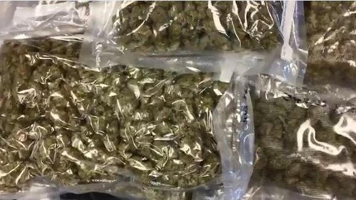 Sixty-five pounds of marijuana and a stolen handgun were found at a Hickory police dispatcher's home in Catawba County, officials said Tuesday.