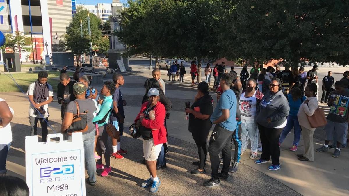 Families of Charlotte-Mecklenburg high school students line up outside ImaginOn Library on Saturday for the E2D laptop distribution.