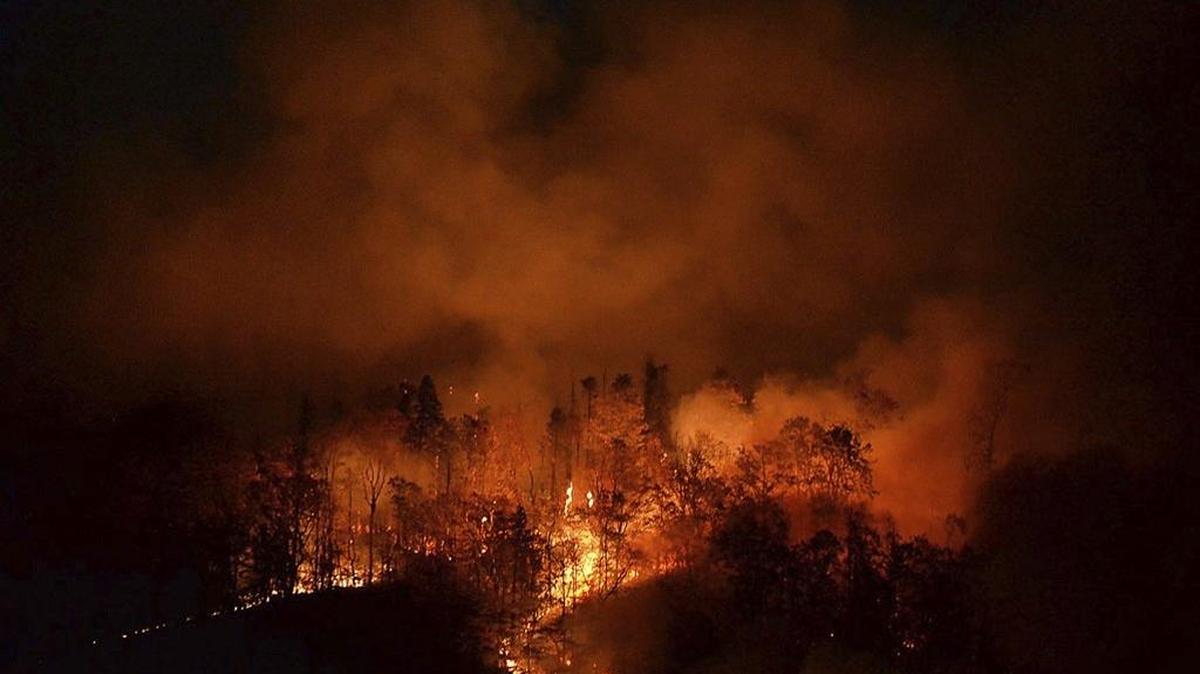 In this Nov. 15, 2016 photo, a wildfire burns as it approaches Bat Cave, N.C. Dozens of uncontrolled wildfires burned in the mountains during a drought that year. One reached the town of Gatlinburg, Tenn., killing 14 people (Patrick Sullivan/The Times-News via AP)
