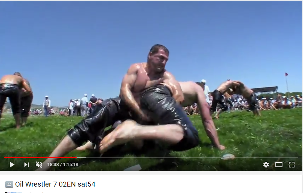 Charlotte resident Gökhan Mekik (center) wrestles an opponent in a frame from “The Oil Wrestler,” a documentary about his quest to compete in the Turkish national sport at age 40.