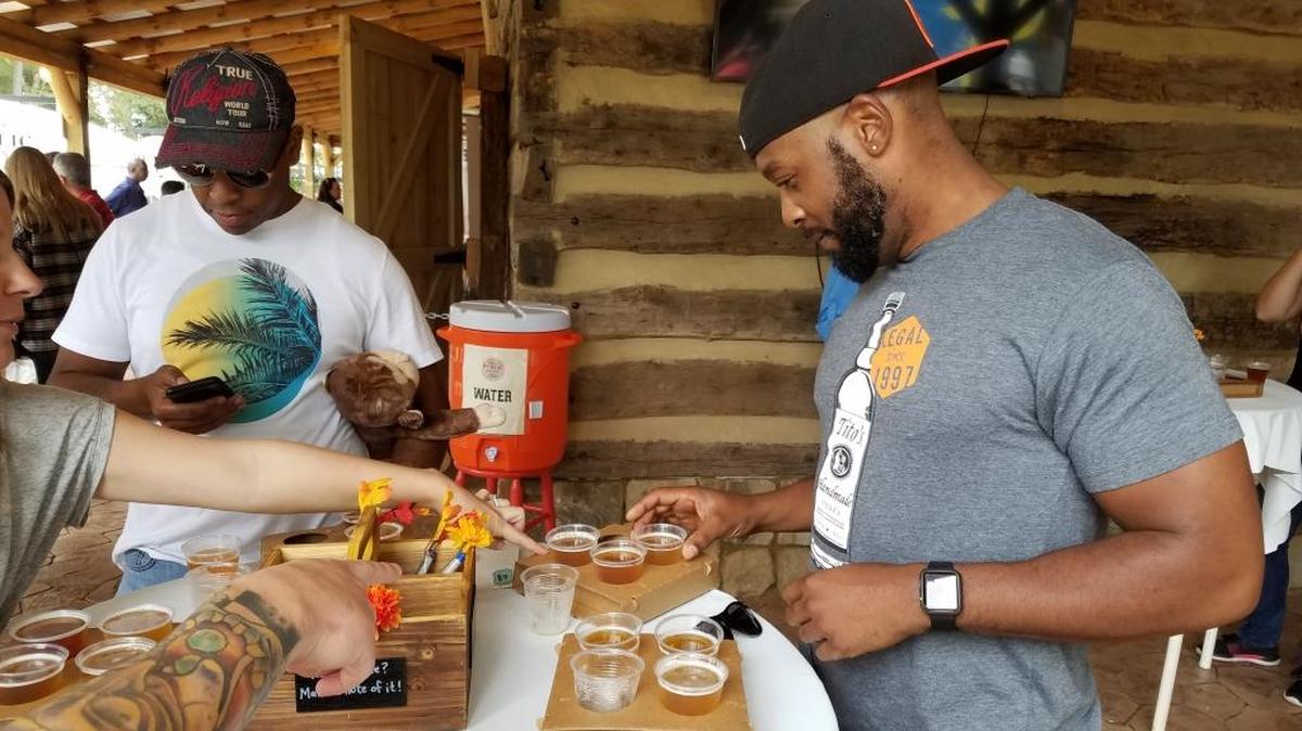 Jason Whye, left, and Jamal Foster sample beer Saturday at the Our State Public House at the N.C. State Fair.