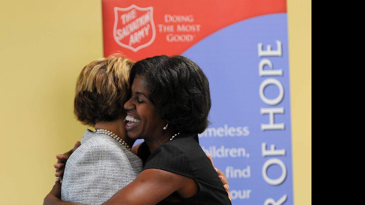 
Deronda Metz, Director of Social Services The Salvation Army of Greater Charlotte hugs Vi Lyles, Charlotte City Council at large member prior to a ribbon cutting ceremony for the new third floor space, "The Loft" at the Salvation Army Center of Hope on Wednesday, July 22, 2015.
