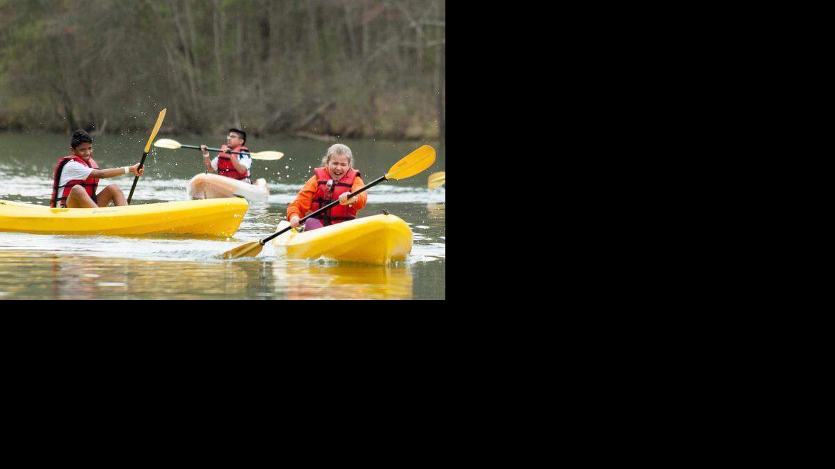 
Leo Dominguez, left, splashes Kryisa Bryant while kayaking on the Catawba River on Thursday in Charlotte. A clash on the Catawba River between the rights of power boaters and the safety of paddlers – lots and lots of paddlers – has prompted action in Raleigh. The focus is the narrow, river-like portion of Lake Wylie near the U.S. National Whitewater Center northwest of Charlotte. 
