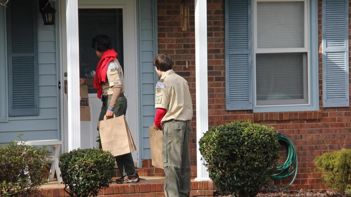 Boy Scouts deliver empty Scouting For Food bags to the Fieldlark Trail neighborhood in Mint Hill.
