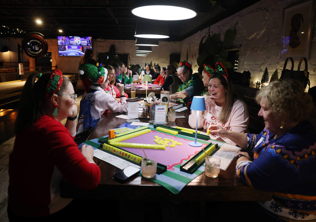 Groups of women play mahjong during Eastside Mahjong’s ugly sweater event at Salud Cerveceria in Charlotte.
