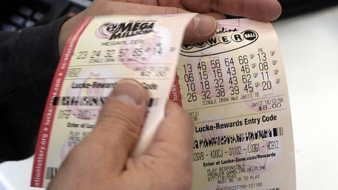 A customer shows off his lottery tickets, including one for the upcoming Powerball drawing, while at the Highland Creek BP in Charlotte,Tuesday, January 12, 2016. On Tuesday afternoon the Powerball jackpot rose to an estimated $1.5 billion.