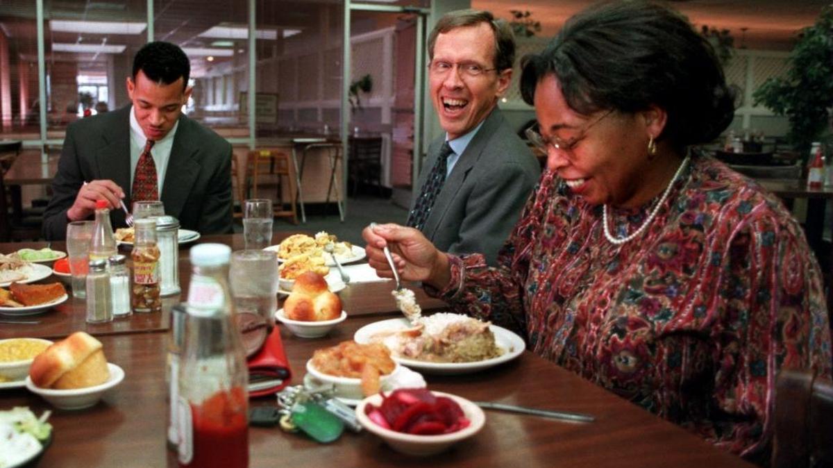 In a photo from 1997, the late Joe Martin (center) enjoys a “Race Day” lunch with Bobby Singleton (left) and Cylvia Haddar (right). Martin came up with the idea for everyone in Charlotte to try to have lunch with someone of another race on Thursdays.
