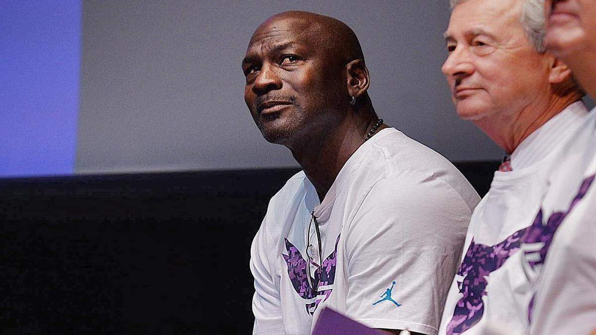 
Sitting beside CPCC President Tony Zeiss, Michael Jordan waits to be introduced to officially announce an edition to their Day of Service project, the “Swarm to Service,” which will benefit military vets in Charlotte. 
