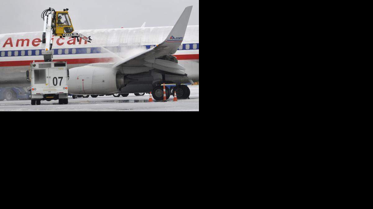 
An American Airlines jet is deiced early Tuesday morning. More than 200 passengers spent Tuesday night in the terminal at Charlotte Douglas International Airport. Cots, mats, pillows and blankets were distributed. 


