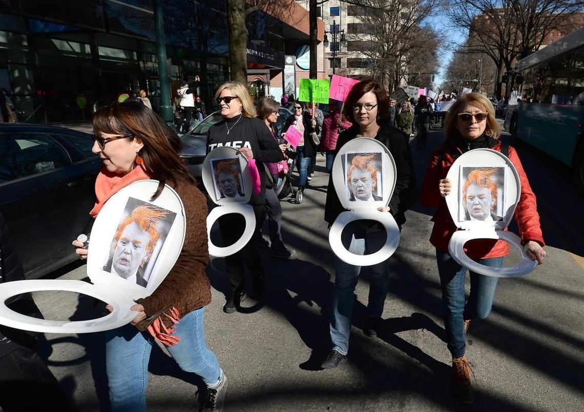 The 2018 women’s march in Charlotte featured plenty of anti-Trump imagery, including his portrait attached to toilet seats.